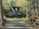 Charming home with a welcoming front porch, manicured lawn, and mature trees at 1229 Westerham Dr, Wake Forest, NC 27587