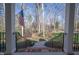 Front entrance with brick walkway, landscaped beds, railing and flag at 1229 Westerham Dr, Wake Forest, NC 27587