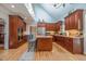 Kitchen with warm wood cabinets, stainless steel appliances, island, and a bright, airy feel with skylight at 1229 Westerham Dr, Wake Forest, NC 27587