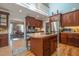 Open kitchen with a central island, wood cabinetry, and a view towards the formal dining area at 1229 Westerham Dr, Wake Forest, NC 27587