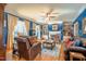 Living room with blue walls, fireplace, bookshelves, and ceiling fan at 1229 Westerham Dr, Wake Forest, NC 27587