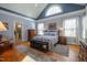 Spacious main bedroom with vaulted ceilings, hardwood floors, and large windows providing ample light at 1229 Westerham Dr, Wake Forest, NC 27587