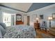Open main bedroom with a walk-out to sunroom, wooden floors, and warm, neutral-colored decor at 1229 Westerham Dr, Wake Forest, NC 27587