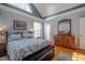 Well-lit main bedroom featuring a large window, wooden floors, and warm, neutral-colored decor at 1229 Westerham Dr, Wake Forest, NC 27587