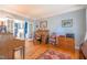 Office space with hardwood floors, roll top desk, and views of the living room at 1229 Westerham Dr, Wake Forest, NC 27587