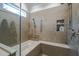 Shower with marble surround and trim features a built-in bench and toiletry storage at 1229 Westerham Dr, Wake Forest, NC 27587