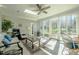 Bright sunroom with a ceiling fan, tile floor, and great natural light from all the windows at 1229 Westerham Dr, Wake Forest, NC 27587