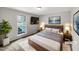 Bright bedroom with a large window, TV, and stylish decor at 129 Bridges Ln, Youngsville, NC 27596