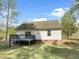 Back exterior featuring a deck and well-maintained yard at 129 Bridges Ln, Youngsville, NC 27596