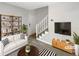 Bright, staged living room with stylish decor and staircase to upper level at 129 Bridges Ln, Youngsville, NC 27596