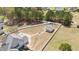 Aerial view of a partially fenced backyard, outbuilding, and hot tub situated in a quiet neighborhood at 14 E Saddle Ct, Archer Lodge, NC 27527