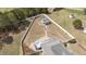 Aerial view of a fenced backyard oasis with a pool, covered patio, and a separate outbuilding at 14 E Saddle Ct, Archer Lodge, NC 27527