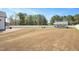 Fenced backyard features a fire pit, patio area, and a detached structure, perfect for recreation and relaxation at 14 E Saddle Ct, Archer Lodge, NC 27527