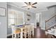 Breakfast nook features hardwood floors, white chairs and ceiling fan with windows at 14 E Saddle Ct, Archer Lodge, NC 27527