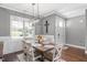 Bright dining room featuring hardwood floors, a modern light fixture, and views of the front yard at 14 E Saddle Ct, Archer Lodge, NC 27527