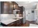 Modern kitchen featuring stainless steel appliances, a subway tile backsplash, and dark wood cabinets at 14 E Saddle Ct, Archer Lodge, NC 27527