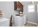 Laundry room features front loading washer and dryer and storage cabinets at 14 E Saddle Ct, Archer Lodge, NC 27527