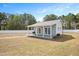 This outbuilding has light gray siding, double doors, covered patio, and is fenced at 14 E Saddle Ct, Archer Lodge, NC 27527