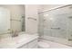 Bathroom with modern vanity, updated faucet, and walk-in shower with glass doors at 1409 Turner Farms Rd, Garner, NC 27529