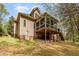 Back exterior showcasing the two-story home, screened porch, and lush backyard at 1409 Turner Farms Rd, Garner, NC 27529