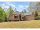 Beautiful single-Gathering home with mature landscaping, a neutral exterior, and an attached two-car garage nestled amongst tall trees at 1409 Turner Farms Rd, Garner, NC 27529