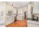 Stylish kitchen featuring stainless appliances, granite countertops, and custom cabinets accented by modern backsplash and hardwood floors at 1409 Turner Farms Rd, Garner, NC 27529