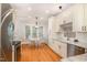 Bright kitchen featuring stainless appliances, granite countertops, custom cabinets, and a breakfast nook with hardwood floors at 1409 Turner Farms Rd, Garner, NC 27529