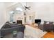 Cozy living room with a fireplace, vaulted ceilings, large windows, and modern furnishings for a comfortable and inviting atmosphere at 1409 Turner Farms Rd, Garner, NC 27529