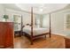 Spacious main bedroom with a four-poster bed, hardwood flooring, and ample natural light at 1409 Turner Farms Rd, Garner, NC 27529