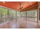 Relaxing screened porch with wood floors, ceiling fan, and view of surrounding woods at 1409 Turner Farms Rd, Garner, NC 27529