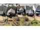 An aerial view shows the patio, landscaping and backyard of homes nestled in a desirable neighborhood at 142 Old Piedmont Cir, Chapel Hill, NC 27516