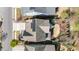 An overhead view showcasing the home's roof, landscaping, stone patio, and surrounding neighborhood at 142 Old Piedmont Cir, Chapel Hill, NC 27516