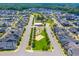 Aerial view showcasing a well planned neighborhood with a playground and green spaces at 142 Old Piedmont Cir, Chapel Hill, NC 27516