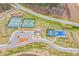 Scenic aerial view showcasing tennis courts, pickleball courts, and a basketball court for community recreation at 142 Old Piedmont Cir, Chapel Hill, NC 27516