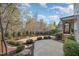 Well-maintained backyard with a patio, stepping stones, and mature landscaping at 142 Old Piedmont Cir, Chapel Hill, NC 27516
