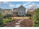 Large backyard featuring a patio and walkway amidst lush landscaping at 142 Old Piedmont Cir, Chapel Hill, NC 27516