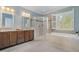 Bathroom featuring dual sinks, a glass shower, and a soaking tub under a window at 142 Old Piedmont Cir, Chapel Hill, NC 27516