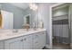 Bright bathroom featuring a double vanity with white cabinetry and a doorway to an adjacent room at 142 Old Piedmont Cir, Chapel Hill, NC 27516