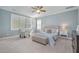Comfortable bedroom with a tray ceiling, plush carpeting, and a large window at 142 Old Piedmont Cir, Chapel Hill, NC 27516