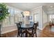 Cozy dining area featuring a round table, shuttered windows for natural light, and hardwood floors at 142 Old Piedmont Cir, Chapel Hill, NC 27516