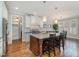 A modern kitchen featuring a granite-topped island with seating, stainless steel appliances, and pendant lighting at 142 Old Piedmont Cir, Chapel Hill, NC 27516