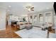 An open-concept living room features hardwood floors, a fireplace, recessed lighting, and a comfortable seating arrangement at 142 Old Piedmont Cir, Chapel Hill, NC 27516