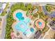 Aerial view of the community pool with slide and play area, surrounded by trees at 142 Old Piedmont Cir, Chapel Hill, NC 27516