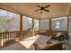 Relaxing screened porch with wood ceiling, ceiling fan and comfortable wicker chairs at 142 Old Piedmont Cir, Chapel Hill, NC 27516