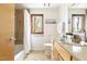 Bright bathroom with tile floor, granite countertops, tub and shower, and an abundance of natural light at 1516 Cumberland Rd, Chapel Hill, NC 27514