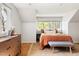 Bright bedroom featuring hardwood floors, a dresser, and a warm color palette at 1516 Cumberland Rd, Chapel Hill, NC 27514