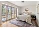 Light-filled bedroom with hardwood floors, featuring a large window with serene outdoor views at 1516 Cumberland Rd, Chapel Hill, NC 27514