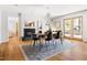 Dining room with modern black chairs, stylish rug, fireplace, and access to the backyard at 1516 Cumberland Rd, Chapel Hill, NC 27514