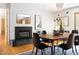 Dining room featuring a black fireplace, stylish decor, and a door to the kitchen at 1516 Cumberland Rd, Chapel Hill, NC 27514
