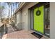 Charming entrance with a bright green door, brick landing, and a welcoming wreath at 1516 Cumberland Rd, Chapel Hill, NC 27514